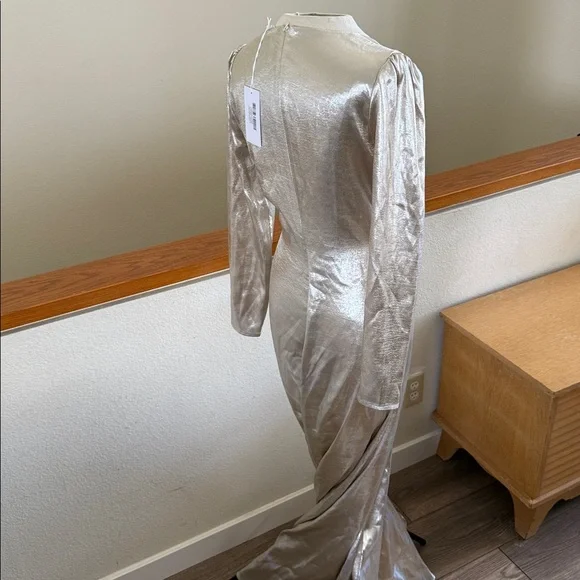 This is a Reformation Gatsby Dress in a silver or champagne color new with tags